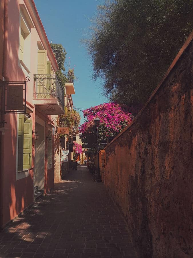 Beautiful atmospheric alleyway in Chania, Crete with blooming flowers!