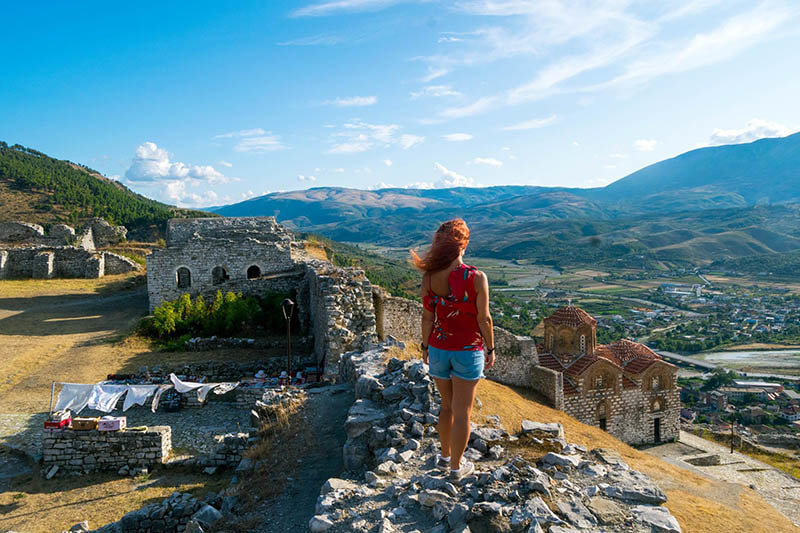 Beautiful photo of girl enjoying view from Berat castle in Berat Albania. Foto e bukur e vajzës që shijon pamjen nga kështjella e Beratit në Berat të Shqipërisë.