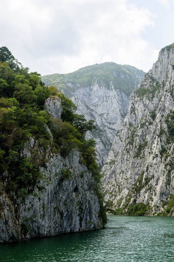 View from Lake Komani Ferry in Albania. This beautiful boat ride is one of the best things to do in Albania! #travel #Albania #Balkans