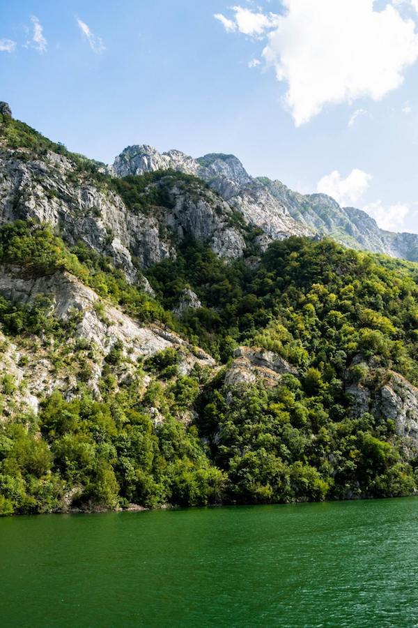 View from Lake Komani Ferry in Albania. This beautiful boat ride is one of the best things to do in Albania! #travel #Albania #Balkans