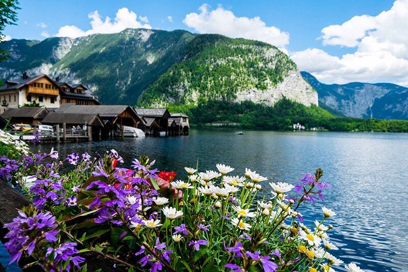 Beautiful view of Hallstatter See from a restaurant in Hallstatt, including boats along wooden docks.