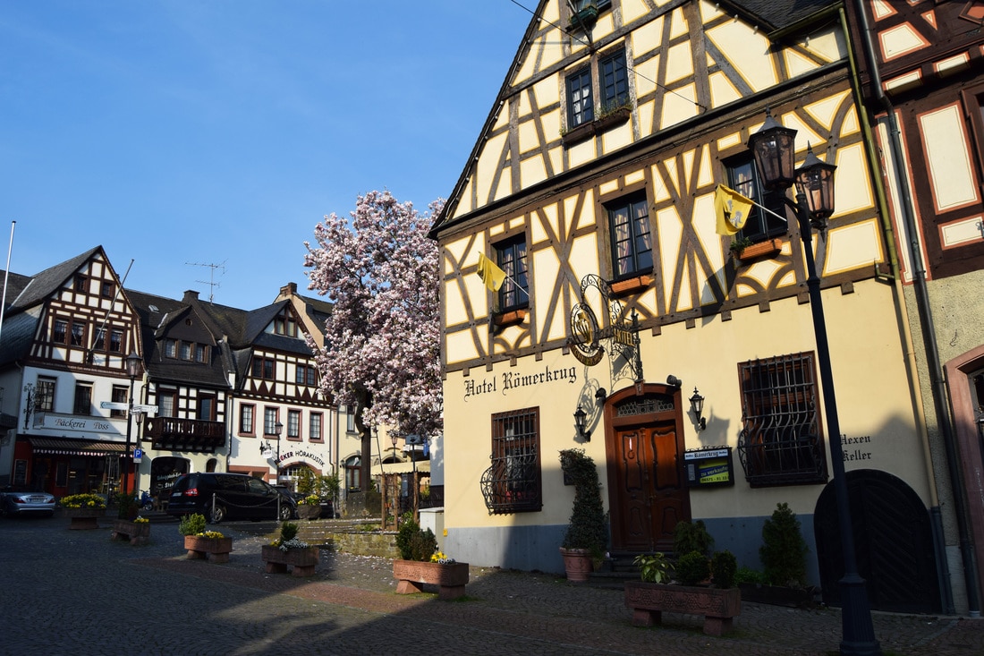 Visit the Rhine Valley wine region in Germany on a budget, including staying IN a castle, which Rhine Valley castles to visit, which towns to explore, and taste the famous wine. All without a river cruise!