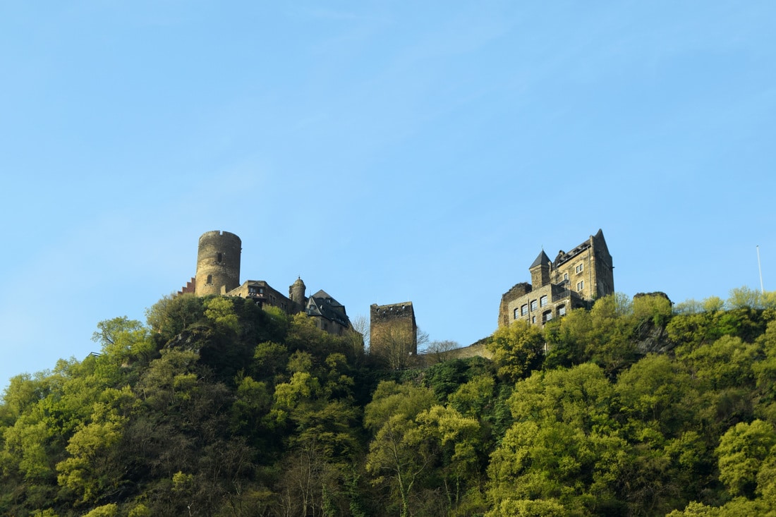 Visit the Rhine Valley wine region in Germany on a budget, including staying IN a castle, which Rhine Valley castles to visit, which towns to explore, and taste the famous wine. All without a river cruise!