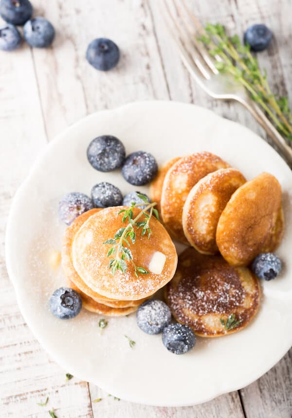 Poffertjes, little Dutch pancakes, that you must eat in Amsterdam, the Netherlands. These delicious Dutch snacks are easy to find at the markets in Amsterdam! #netherlands #amsterdam #Holland