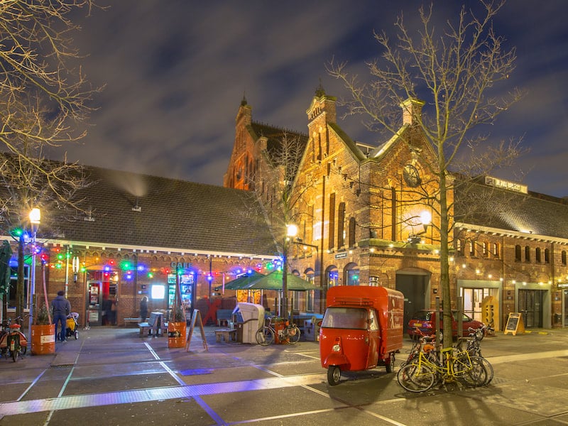 Photo of Westergasfabriek in Amsterdam. This former factory is a great non-touristy place to visit to Amsterdam to see how locals live. Read more tips on Amsterdam's best kept secrets! #Amsterdam