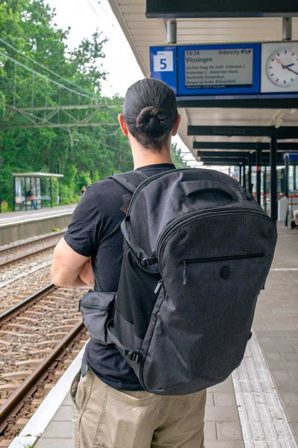 Man waiting for train in the Netherlands. Read tips for finding cheap trains in the Netherlands! #travel #netherlands